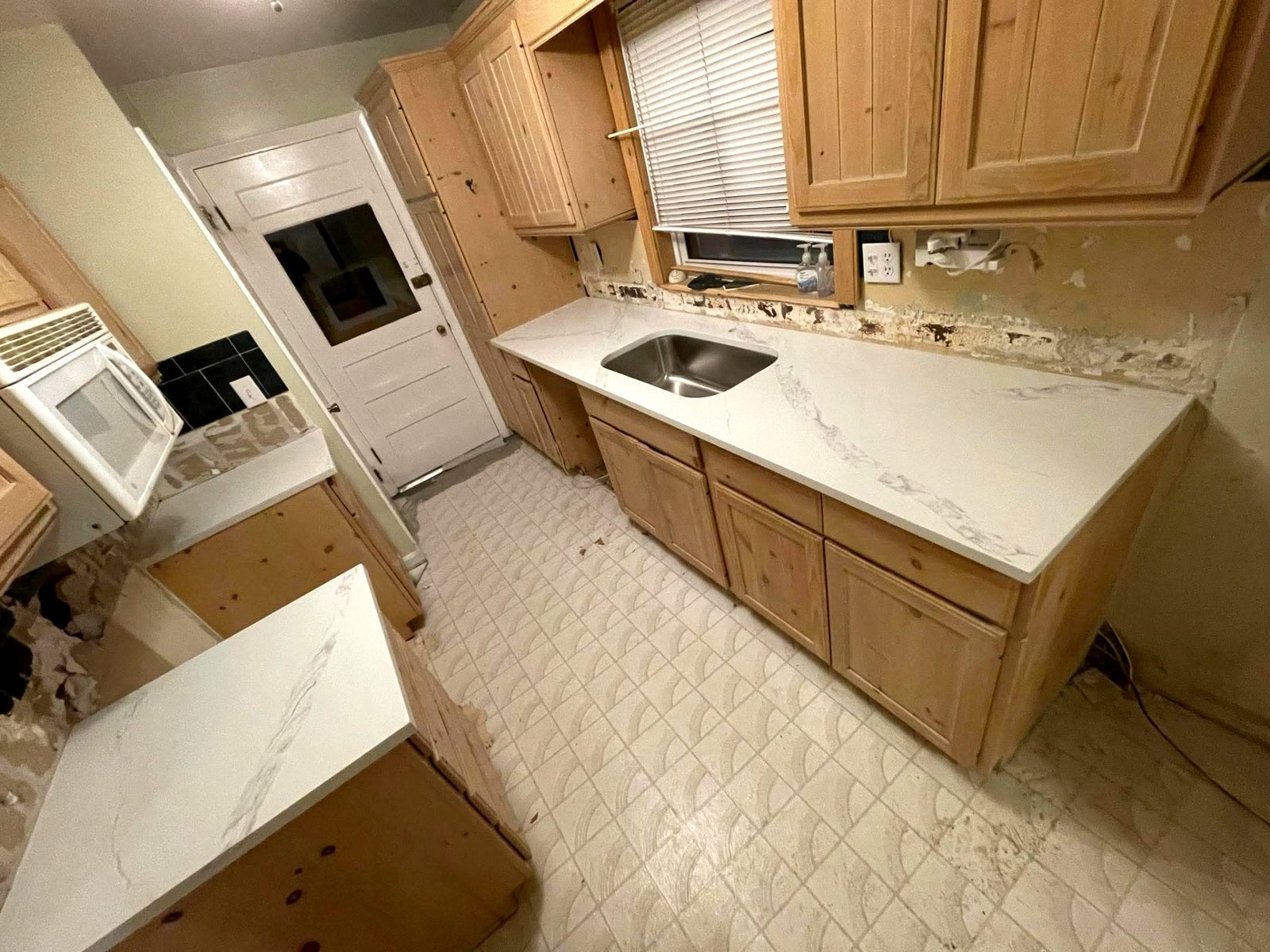 Galley Kitchen Refresh — Marble-look quartz counters with an undermount stainless sink
